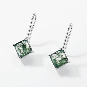 Pair of green square gemstone earrings on a white background