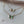 Butterfly-shaped necklaces on a marble surface