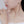 Close-up of a woman wearing pearl earrings and a necklace with a white background