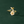 Gold ring with floral designs on a dark green background