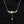 Gold necklace with floral design and pendant on a black background