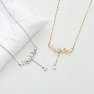 Two necklaces, one silver and one gold, on a light background