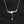 Silver necklace with floral pendants on a black background