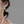 Close-up of a person wearing a floral earring with a blurred background