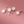 Set of floral earrings on a pink background