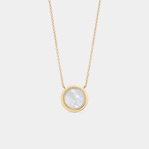 Gold plated round locket necklace featuring a mother of pearl center with a halo of small clear stones, on a delicate chain against a white background.