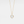 Gold necklace with a round mother of pearl locket on a light gray background