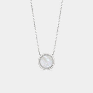 White gold plated round locket necklace featuring a mother of pearl center with a halo of small clear stones, on a delicate chain against a white background.