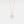 Rose gold necklace with a round mother of pearl locket on a light gray background
