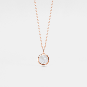 Rose gold necklace with a round mother of pearl locket on a light gray background