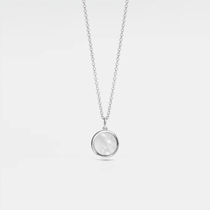 Silver necklace with a round mother of pearl locket on a light gray background