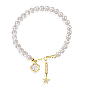 Pearl bracelet with gold starfish and shell charm on a white background