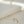 Pearl bracelet with gold starfish and shell charm on a light beige background