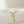 Pearl bracelet with gold starfish and shell charm on a light beige background