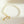 Pearl bracelet with gold starfish and shell charm on a light beige background