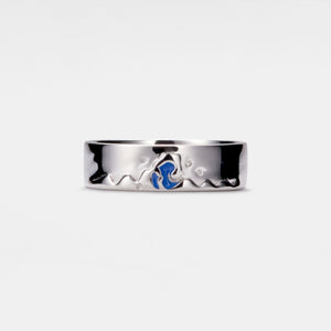 A silver band ring with mountain and ocean designs, symbolizing constancy and eternity.