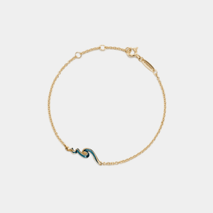 Gold bracelet with a blue wave design on a white background