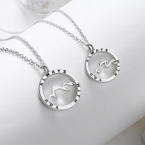 Silver necklaces with circular pendants on a white background