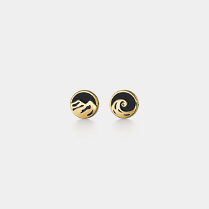 Pair of gold and black earrings on a light gray background