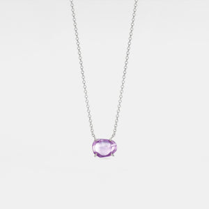 Necklace with a purple gemstone on a light gray background