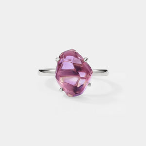 Ring with a pink gemstone on a white background