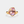 Gold ring with a pink gemstone on a white background