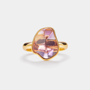 Gold ring with a pink gemstone on a white background