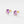 Pair of gold earrings with purple gemstones on a white background
