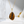 Gold necklace with a tiger's eye pendant on a white surface