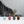 Four gold necklaces with colorful pendant stones on a white surface.
