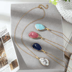 Necklace with colorful pendant stones on a gray surface