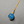Gold necklace with a blue pendant on a gray background