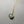 Necklace with a green gemstone pendant on a gray background