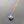 Necklace with a blue pendant on a gray background