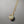 Necklace with a round pendant on a gray background