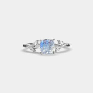 Silver ring with a blue gemstone on a white background