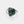 Silver ring with a green stone on a white background