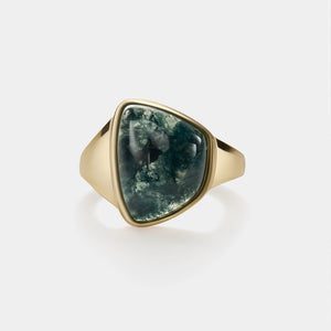 Gold ring with a green stone on a white background
