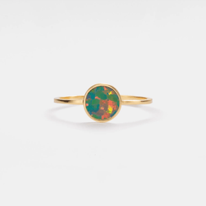Gold ring with a colorful gemstone on a white background