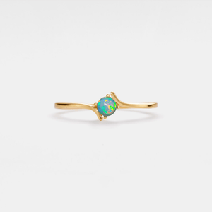 A gold-plated, solid sterling silver bypass ring with a hypoallergenic finish, featuring a natural opal stone in a thin bypass design.