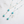 Two turquoise bead necklaces on a marble surface