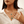 Woman wearing a turquoise necklace with a white blouse
