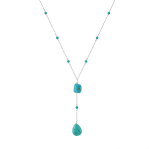 Turquoise necklace with teardrop pendant on a white background