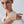 Woman wearing a gold ring on a plain background