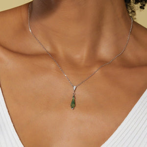 Necklace with a green pendant worn by a person