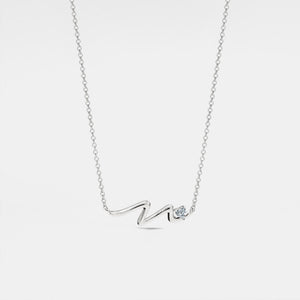 Silver necklace with a diamond pendant on a light gray background