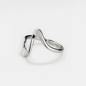 A gold-colored stacking band ring with a wave-inspired design on a white background.