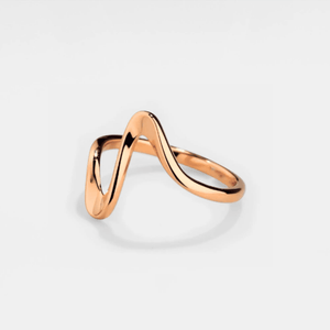 A gold-colored stacking band ring with a wave-inspired design on a white background.