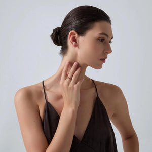 Woman wearing a black dress against a plain background