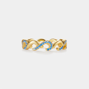 Gold ring with blue gemstones on a white background